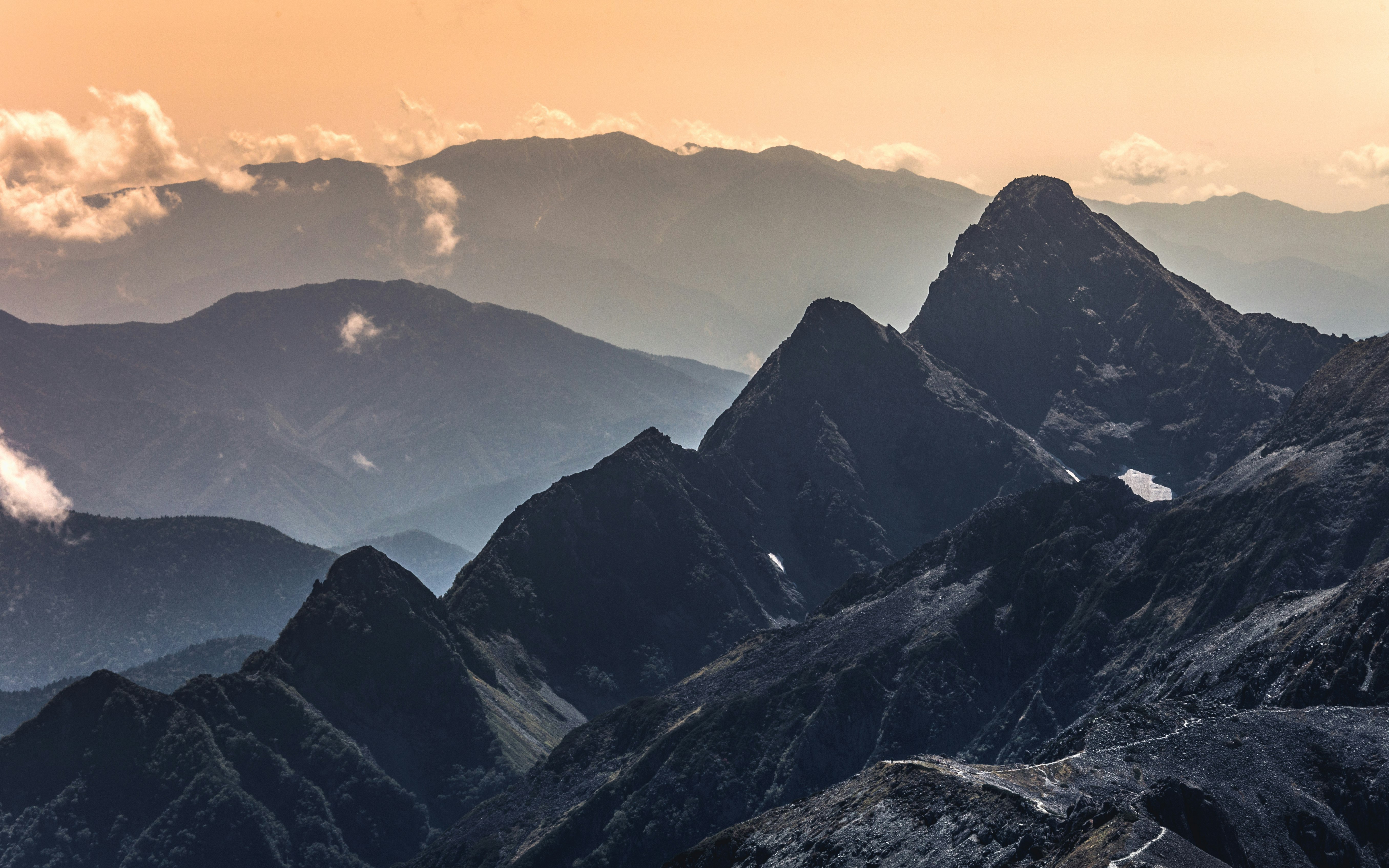 black and white mountains under blue sky during daytime